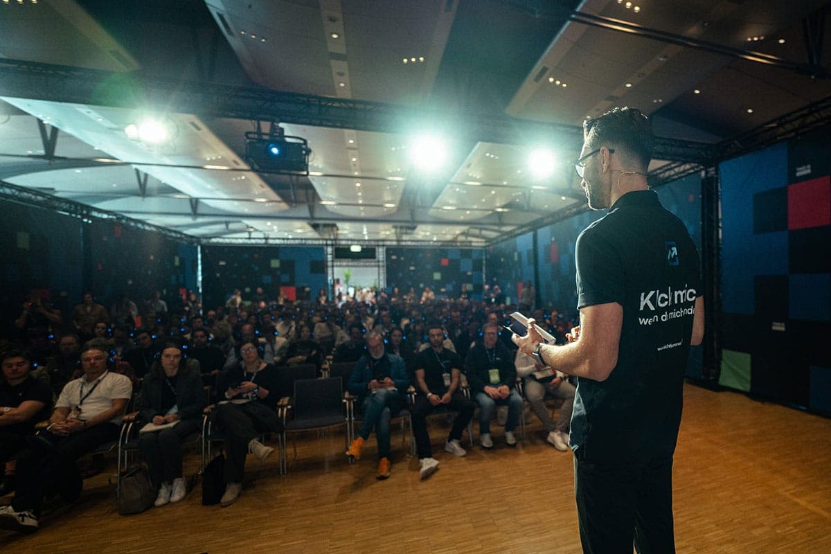 Thomas Gal speaking on stage in front of an audience